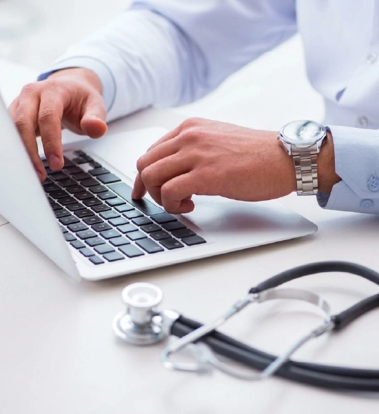 Doctor typing on laptop